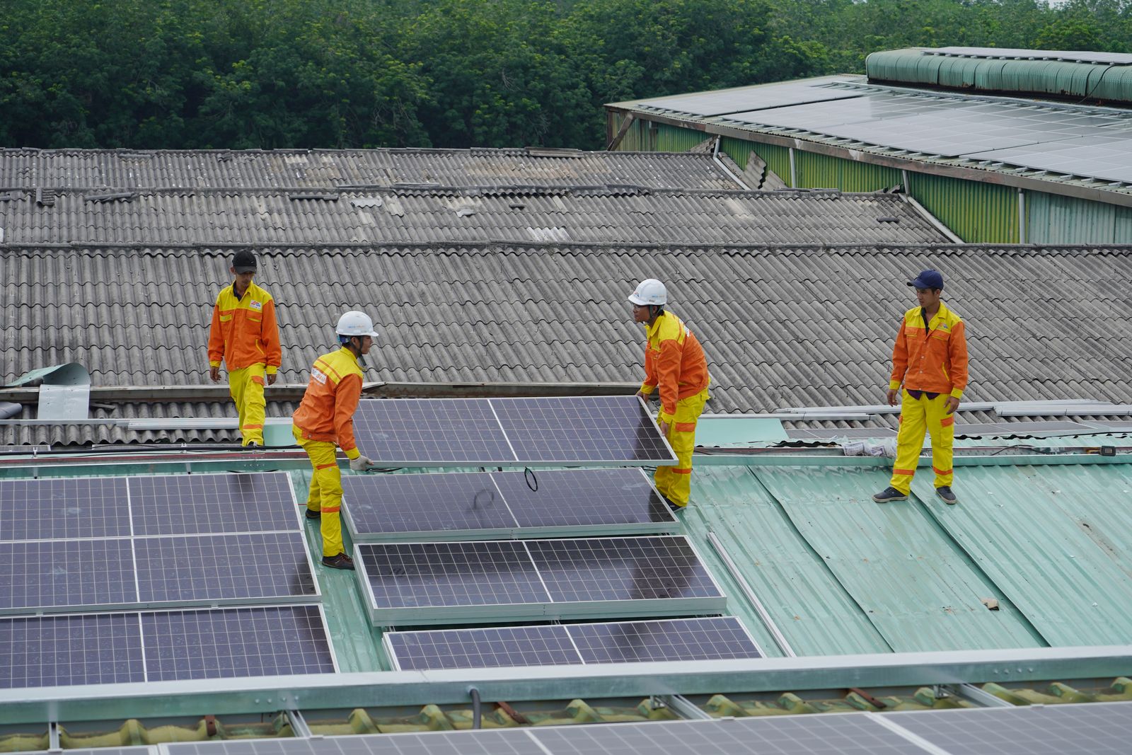 A crew installing solar panels on a rooftop